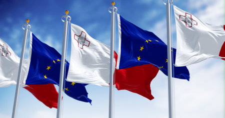 Flags of Malta and the European Union waving in the wind on a clear day. Malta became a member of...