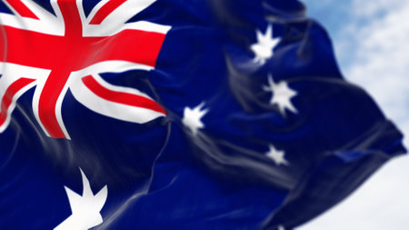 Close-up of Australia national flag waving in the wind on a clear day. Blue flag with Union Jack, white 5-pointed star symbolizing Southern Cross. 3D illustration render. Selective focusの写真素材