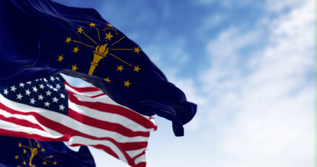 Indiana state flags waving with the national flag of the United states on a clear day. 3d illustration render. Selective focus. Fluttering fabricの写真素材