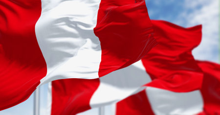Close-up view of Peru national flags waving in the wind. The Republic of Peru is a country in...