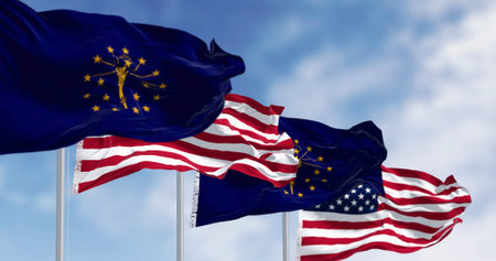 Indiana state flags waving with the national flag of the United states on a clear day. 3d illustration render. Selective focus. Fluttering fabric. Selective focusの写真素材