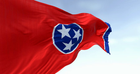 Close-up of the Tennessee state flag waving. Red field with a blue circle in the center containing three white stars. US state flag. 3d illustration render. Fluttering fabric. Selective focusの写真素材