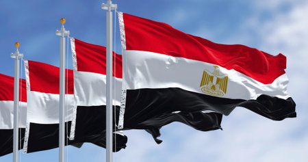 Three National flags of Egypt waving on a clear day. Horizontal red, white and black bands. Egyptian...