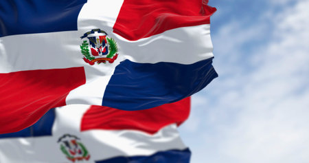 Detail of the national flag of the Dominican Republic waving in the wind on a clear day. Democracy...