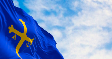 Asturias flag waving in the wind on a clear day. Autonomous community in northern Spain. Blue with golden victory cross. 3d illustration render. Rippling fabric. Selective focusの写真素材