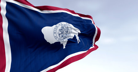 3D render of the Wyoming state flag featuring the bison and state seal, fluttering in the wind and...
