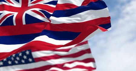 Hawaii state flag waving with the national flags of the United States of America on a clear day. 3d illustration render. Fluttering fabric. Selective focusの写真素材