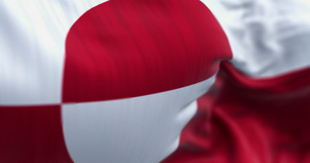 The flag of Greenland, an autonomous territory of Denmark located in the Arctic. Detailed selective focus view of the unique red and white design. 3D illustration.の写真素材