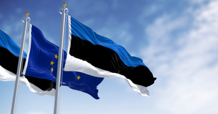 The flags of Estonia and the European Union waving together on a clear day. Estonia became a member of the European Union on May 1, 2004. Realistic 3d illustration. International treaty and diplomacyの写真素材