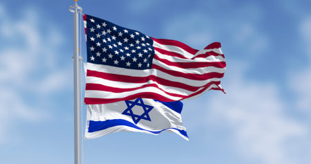 Israel and United States flags waving together on a single flagpole. Concept of alliance, diplomacy and international relations. 3D render.の写真素材