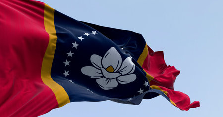 The new Mississippi In God We Trust state flag waving in the wind. A symbol of unity and pride, featuring the magnolia flower. Background for US politics and state government. 3D illustration.の写真素材