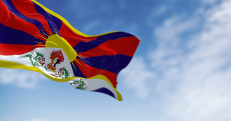 Tibetan flag waving under the sky with snow lions and rising sun. Concept of freedom, identity,...