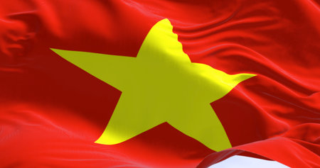 Close up of Vietnam national flag waving in the wind. Red flag with a large yellow five-pointed star in the center. Seamless 3d render animation. Slow motion loopの写真素材