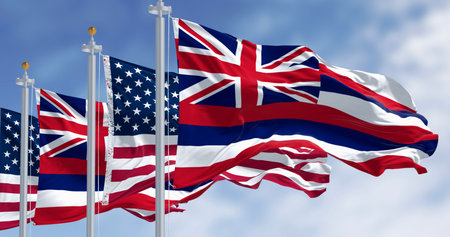 Hawaii state flags waving with the national flags of the United States of America on a clear day. 3d...