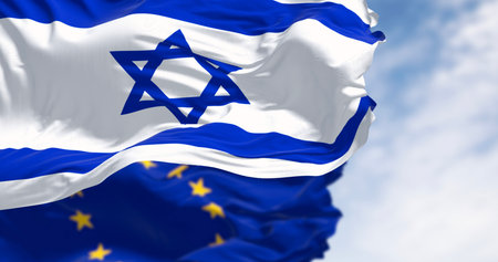 State of Israel national flag waving in the wind with the European Union flag. The European Union and Israel maintain close relations in trade and research. 3d illustration render. Rippling fabricの写真素材