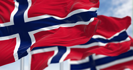 Norway national flags waving in the wind on a clear day. Red field with a blue cross with white outline. 3D illustration render. Selective focus. Rippled fabricの写真素材
