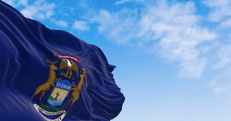 Close-up of Michigan state flag waving in the wind. Dark blue flag with state coat of arms featuring an eagle, an elk and a moose. 3d illustration render. Rippling fabric. Selective focusの写真素材