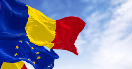 Romania and European Union flags waving in the wind on a clear day. Eu member since January 2007. 3d illustration render. Fluttering fabricの写真素材