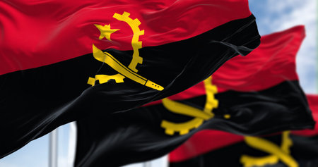 Close-up of Angola national flags waving in the wind on a clear day. Two horizontal bands, red and black, with a yellow emblem in the center. 3d illustration render. Fluttering fabricの写真素材