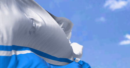 Flag of Altai (Gorno-Altai Republic) waving in the wind on a clear day. Four-striped bicolour of white and light blue. 3d illustration render. Selective focus. Rippled fabricの写真素材