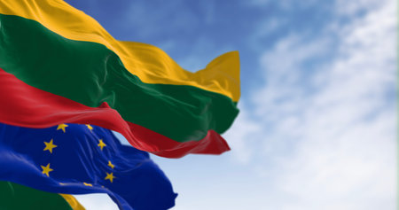 Flags of Lithuania and the European Union waving together on a clear day. Lithuania became a member of the European Union on 2004. 3D illustration render. Rippled fabric. Selective focusの写真素材