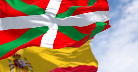 Basque Country and Spanish flags waving in the wind on a clear day. Spanish Autonomous community. 3d illustration render. Selective focusの写真素材