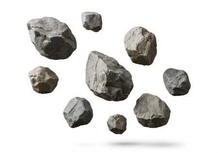 A group of irregularly shaped grey rocks of different sizes suspended against a white background.の素材