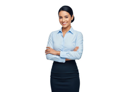 A professional woman with dark hair, wearing a light blue collared shirt and dark skirt, smiles confidently with her arms crossed.の素材