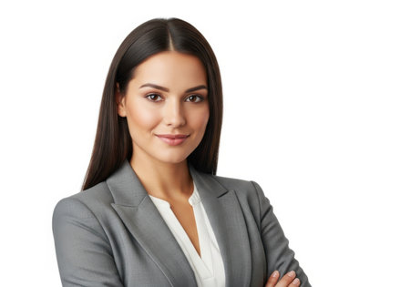 A confident young businesswoman with long dark hair, wearing a gray suit and white blouse, poses with her arms crossed.の素材
