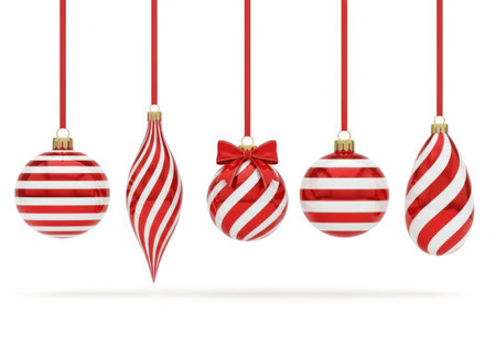 Five festive Christmas ornaments with red and white stripes hang from red ribbons against a white background.の素材