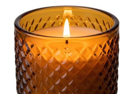 Burning wax candle in a candlestick isolated on white backgroundの素材