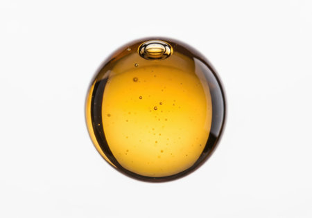 Olive oil drop isolated on white background. Close-up.の素材