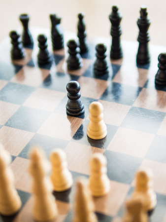 Black and white chess in the center of board, Means the competition, Shallow in depth of fieldの写真素材