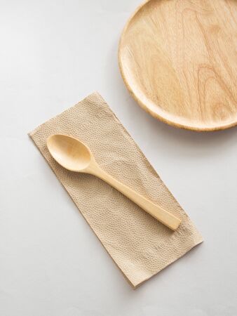 Wooden dish with spoon and napkinの写真素材