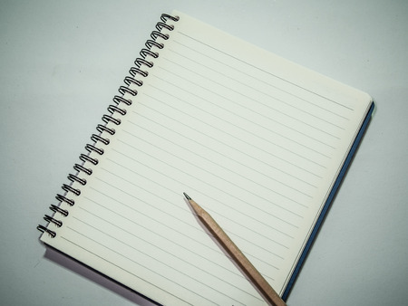 Notebook with pencil on grey table, Tonal contrast processed