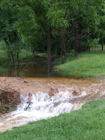 nature: waterfall and pond in green grass and treesの写真素材
