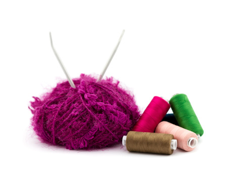 Yarn and colorful sewing thread on white background