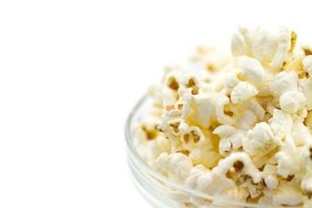 Popcorn in a glass bowl isolated on white backgroundの写真素材