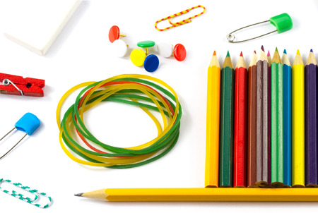Closeup school supplies: colored pencils paper clips pencil sharpener stationery gum small...