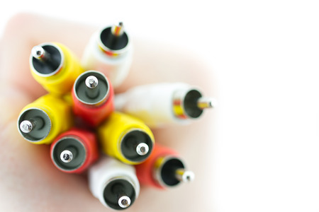 Color AV cable connectors in hand isolated on white backgroundの写真素材