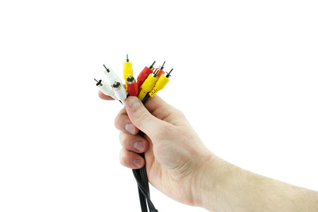 AV cable connectors in hand on white background