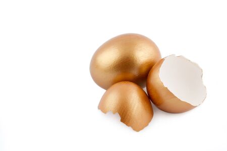 Golden egg with empty broken egg isolated on white background