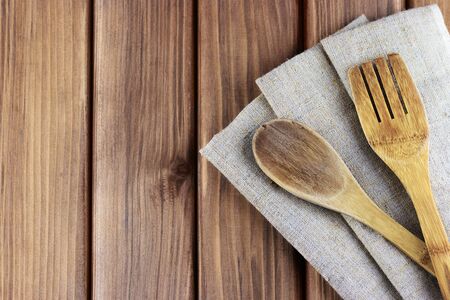 Top view of rustic cutlery with napkin on wooden backgroundの写真素材