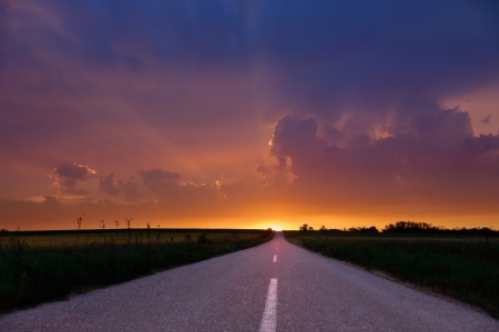 Endless driving on country road at sunset.の写真素材