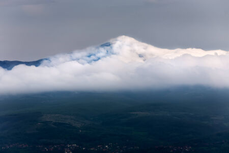 Rtanj mountain covered with low white cloudsの写真素材