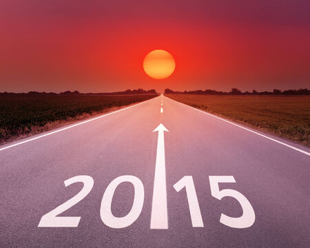 Driving on an empty asphalt road at sunset forward to upcoming new yearの写真素材