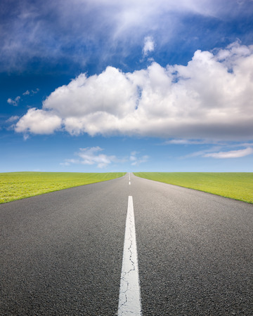 Driving on an empty asphalt road through the agricultural fields の写真素材