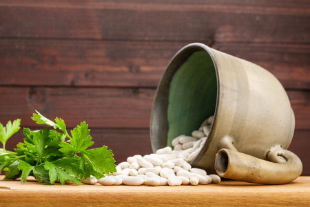 Food background with parsley, beans and ceramic kitchenwareの写真素材