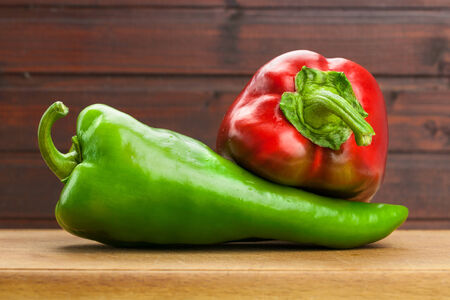 Fresh red and green paprika on wooden boardの写真素材