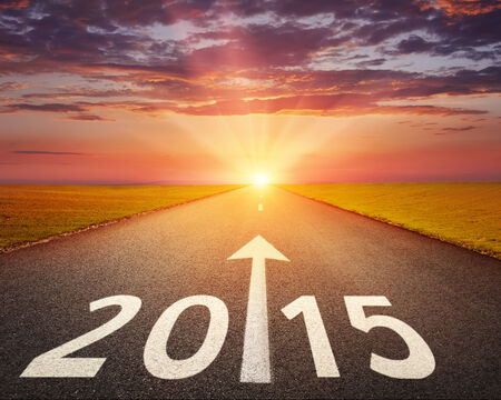 Driving on an empty road at sunset to upcoming 2015